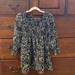 Black and cream (tan) flowers. Too is smocked and 100% polyester.